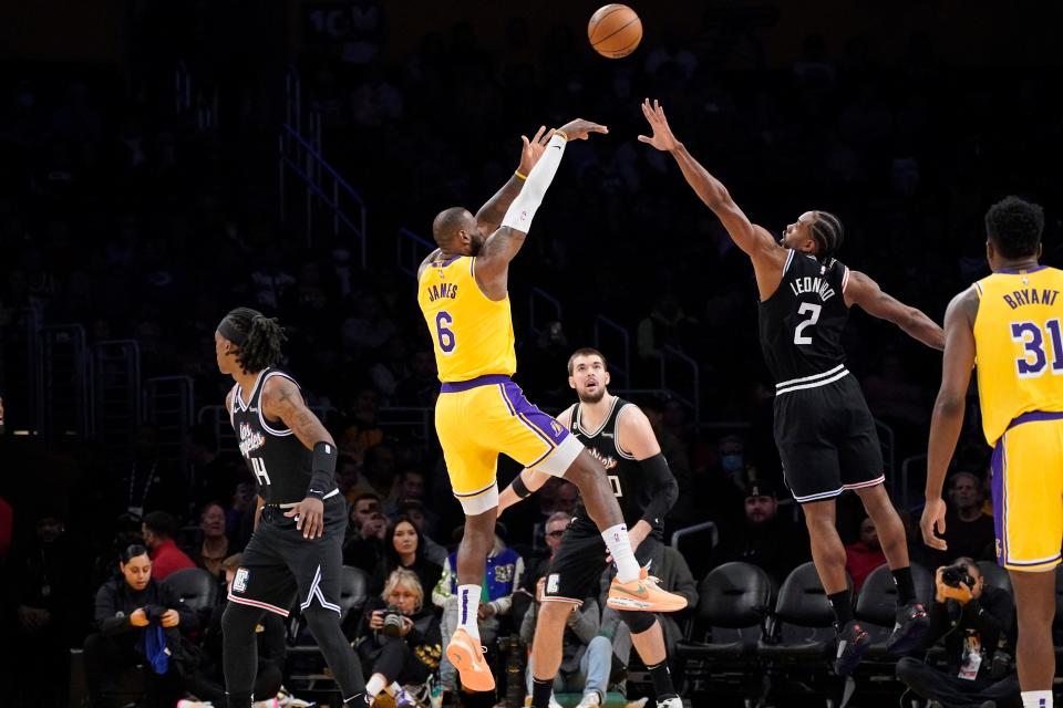 Los Angeles Lakers forward LeBron James (6) shoots as Los Angeles Clippers forward Kawhi Leonard (2) defends and guard Terance Mann (14), center Ivica Zubac (40) and center Thomas Bryant watch during the first half of an NBA basketball game Tuesday, Jan. 24, 2023, in Los Angeles. (AP Photo/Mark J. Terrill)