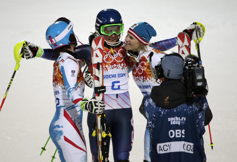 Women's slalom medalists, from left, Austria's Kathrin Zettel (bronze), United States' Mikaela Shiffrin (gold) and Marlies Schild (silver), celebrate at the Sochi 2014 Winter Olympics, Friday, Feb. 21, 2014, in Krasnaya Polyana, Russia.(AP Photo/Gero Breloer)