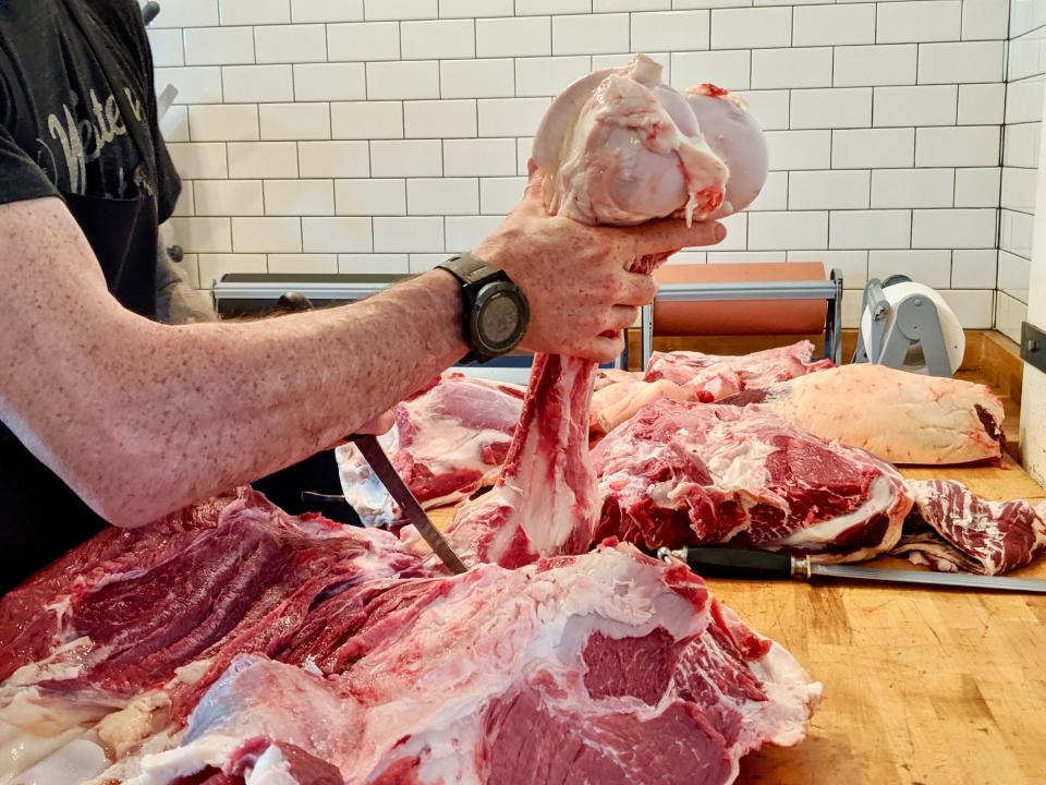 A butcher at Western Daughters in Denver breaks down a cow. (Photo: Lee Breslouer/For HuffPost)