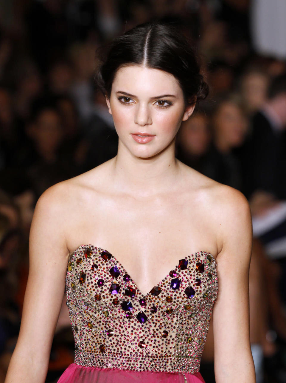 <p>Making her runway debut at the Sherri Hill Spring 2012 show in New York City, Jenner epitomized prom #goals with rosy cheeks and a simple chignon. <i>(Photo: Getty Images)</i></p>