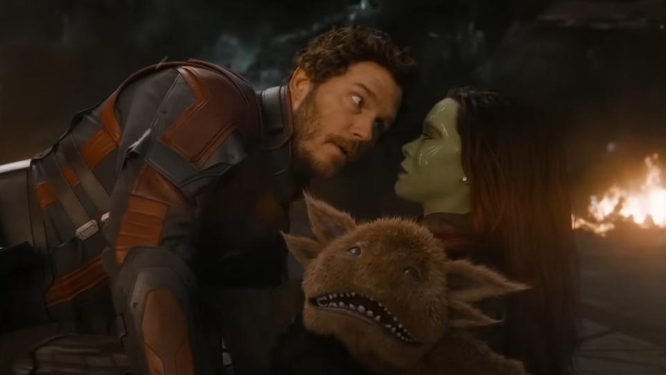 Quill lies on top of Gamora with an alien animal between them in Guardians of the Galaxy Vol. 3