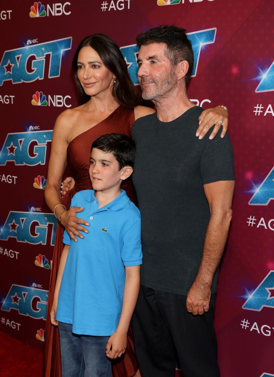 Simon Cowell beamed proudly as he posed with fiancée Lauren Silverman and son Eric (David Livingston/Getty Images)
