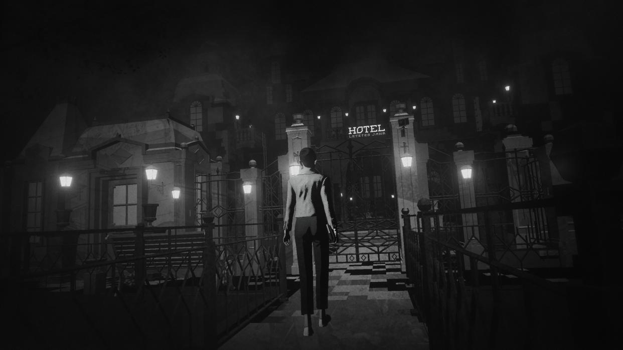  A woman approaches a foreboding hotel. 