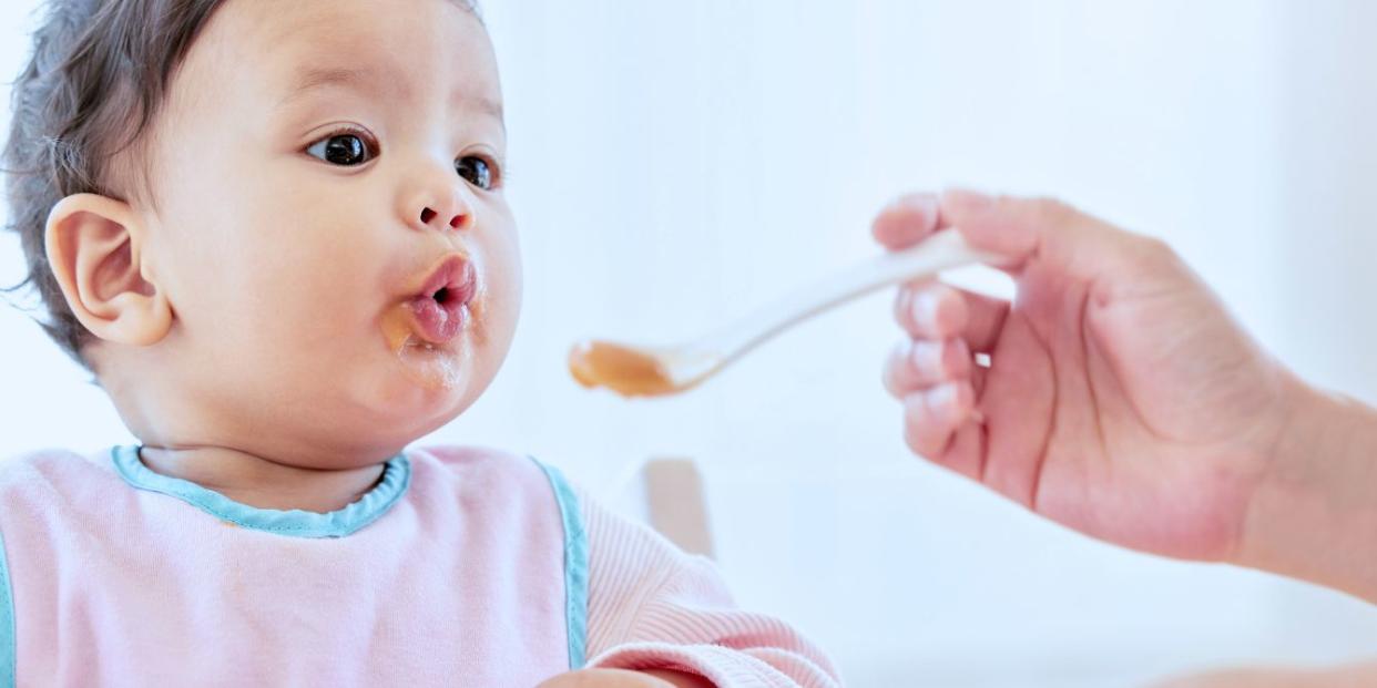 Baby being spoon-fed