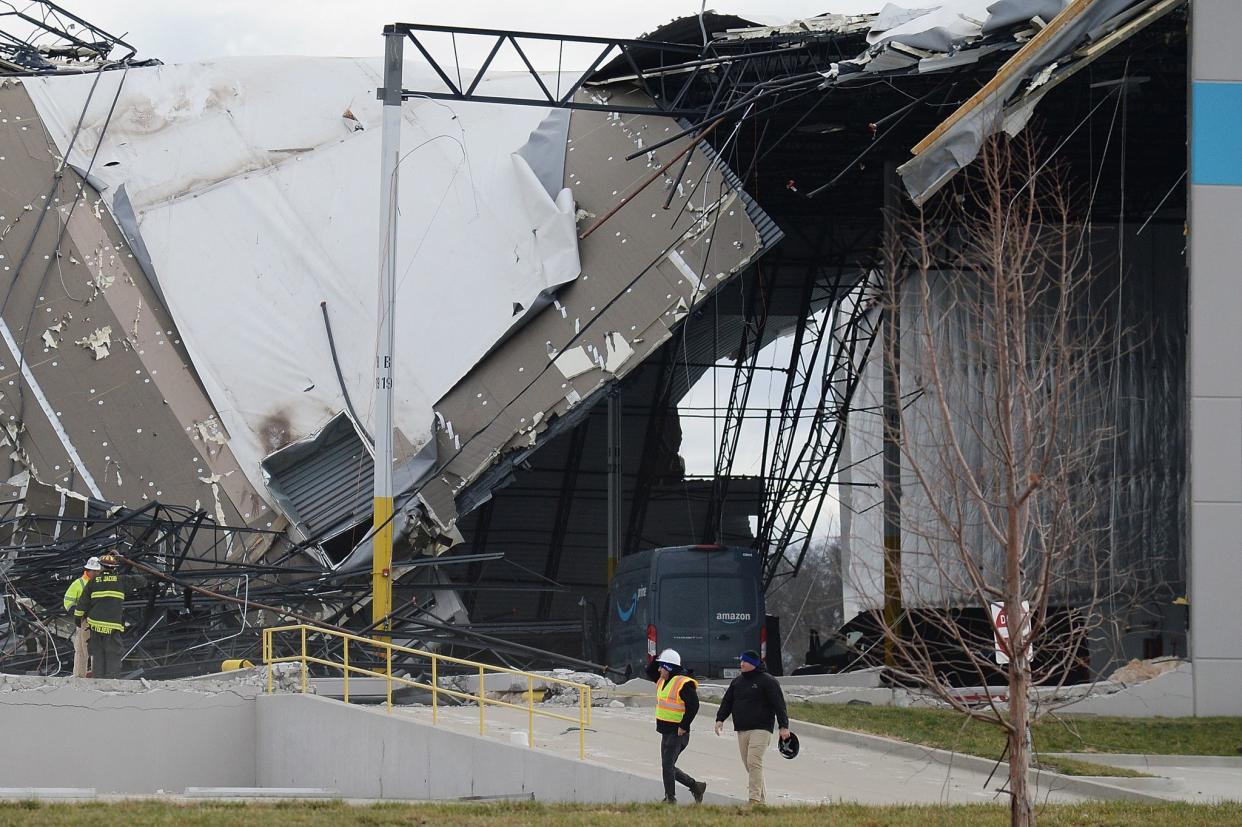 Safety personnel and first responders survey a damaged Amazon Distribution Center on December 11, 2021 in Edwardsville, Illinois. 