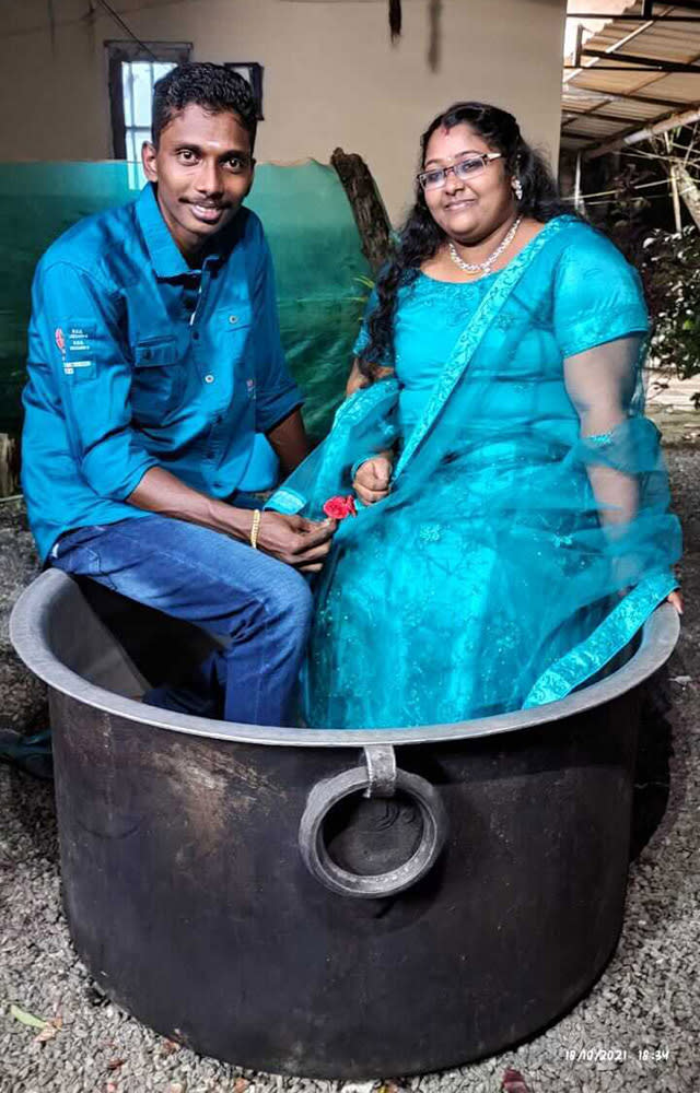 Akash and Aishwarya, an Indian couple who arrived for their wedding in unusual style after sailing through the flooded streets of their town in a cooking pot, Kerala state, India. (Gopan Velu Photo)