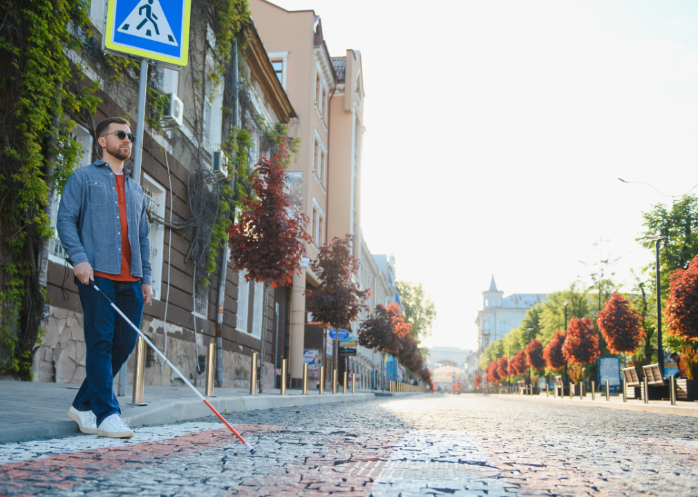 A blind man crossing the street.