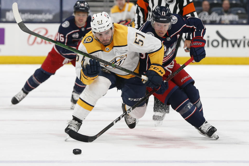 Nashville Predators' Dante Fabbro, left, and Columbus Blue Jackets' Cam Atkinson chase the puck during the second period of an NHL hockey game Wednesday, May 5, 2021, in Columbus, Ohio. (AP Photo/Jay LaPrete)