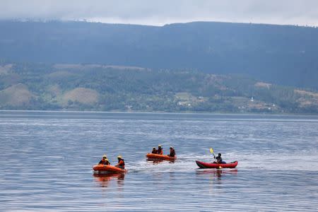 Rescue team members are using rubber boats during the operation to find the missing passengers, after a ferry sank earlier this week in Lake Toba in Simalungun, North Sumatra, Indonesia, June 22, 2018. REUTERS/Beawiharta