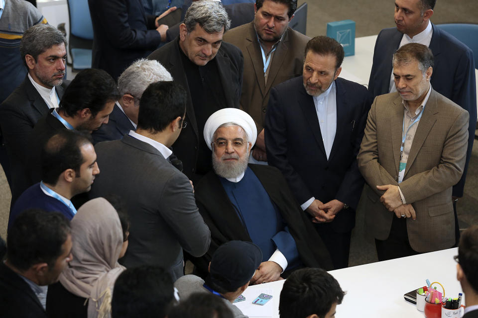 In this photo released by the official website of the office of the Iranian Presidency, President Hassan Rouhani, center, attends a ceremony to inaugurate Azadi Innovation Factory in Pardis technology park in west of Tehran, Iran, Tuesday, Nov. 5, 2019. Rouhani announced on Tuesday that Tehran will begin injecting uranium gas into 1,044 centrifuges, the latest step away from its nuclear deal with world powers since President Donald Trump withdrew from the accord over a year ago. (Office of the Iranian Presidency via AP)