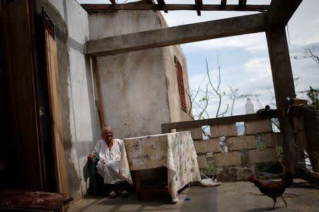 Case Jean, 92, poses for a photograph in her destroyed house after Hurricane Matthew hit Jeremie, Haiti, October 17, 2016. Jean is very old and does not speak, a relative said. REUTERS/Carlos Garcia Rawlins