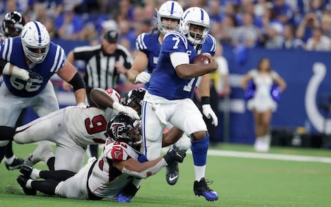 Indianapolis Colts quarterback Jacoby Brissett (7) runs out of the tackle of Atlanta Falcons defensive tackle Jack Crawford (95) during the second half of an NFL football game against the Atlanta Falcons, Sunday, Sept. 22, 2019, in Indianapolis - Credit: AP