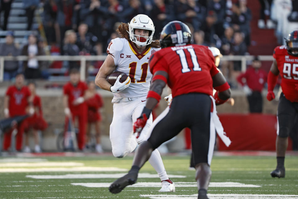 Iowa State's Chase Allen (11) runs with the ball around Texas Tech's Eric Monroe (11) during the second half of an NCAA college football game on Saturday, Nov. 13, 2021, in Lubbock, Texas. (AP Photo/Brad Tollefson)