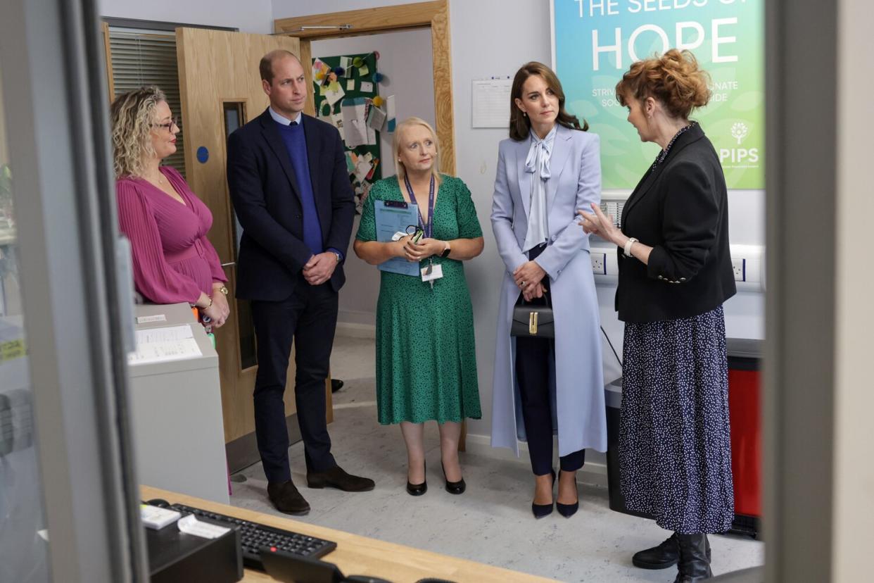 Prince William, Prince of Wales (second left) and Catherine, Princess of Wales (second right) speak with staff and counsellors during their visit to the PIPS (Public Initiative for Prevention of Suicide and Self Harm) charity on October 06, 2022 in Belfast, Northern Ireland