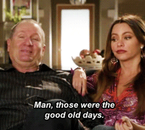 Ed O'Neill and Sofía Vergara from "Modern Family" are sitting together on a couch, with Ed reminiscing, "Man, those were the good old days"