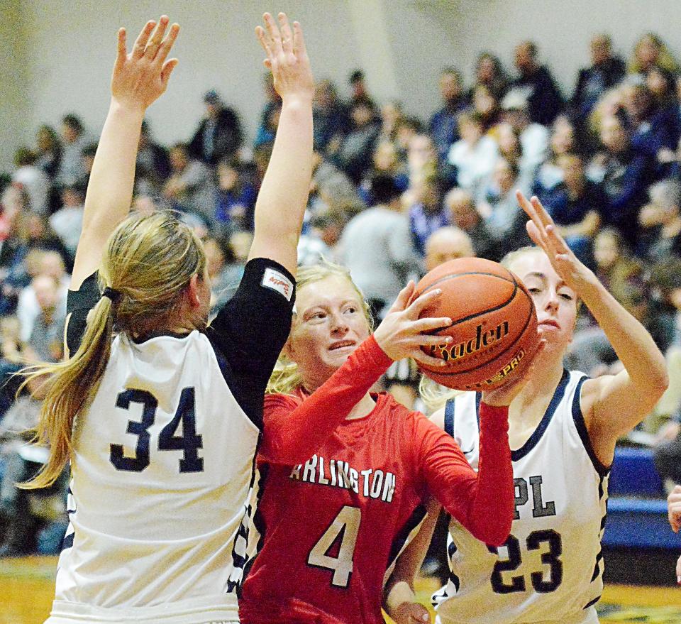 Arlington's Harley Johnson (4) attempts to put up a shot against Great Plains Lutheran defenders Madeline Prahl (34) and Bryn Holmen during a high school girls basketball game on Saturday, Feb. 5, 2022 in Watertown.