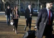 Sunderland soccer player Adam Johnson (C) arrives with his girlfriend Stacey Flounders at Bradford Crown Court in Bradford, Britain February 10, 2016. REUTERS/Andrew Yates