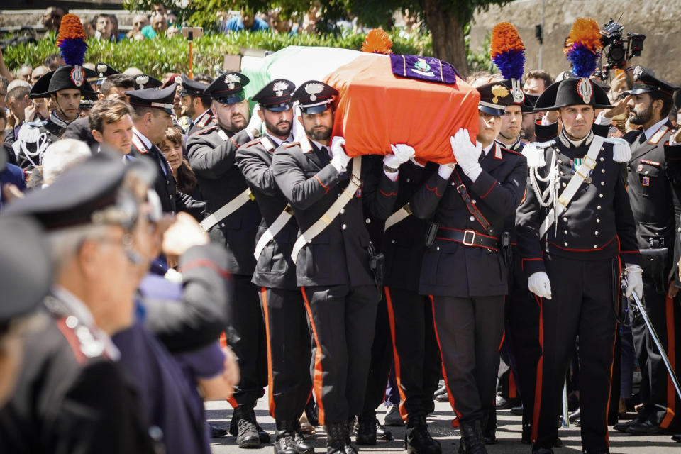The coffin containing the body of the Carabinieri's officer Mario Cerciello Rega is carried during his funeral in his hometown of Somma Vesuviana, near Naples, southern Italy, Monday, July 29, 2019. Two American teenagers were jailed in Rome on Saturday as authorities investigate their alleged roles in the fatal stabbing of the Italian police officer on a street near their hotel. (Cesare Abbate/ANSA via AP)