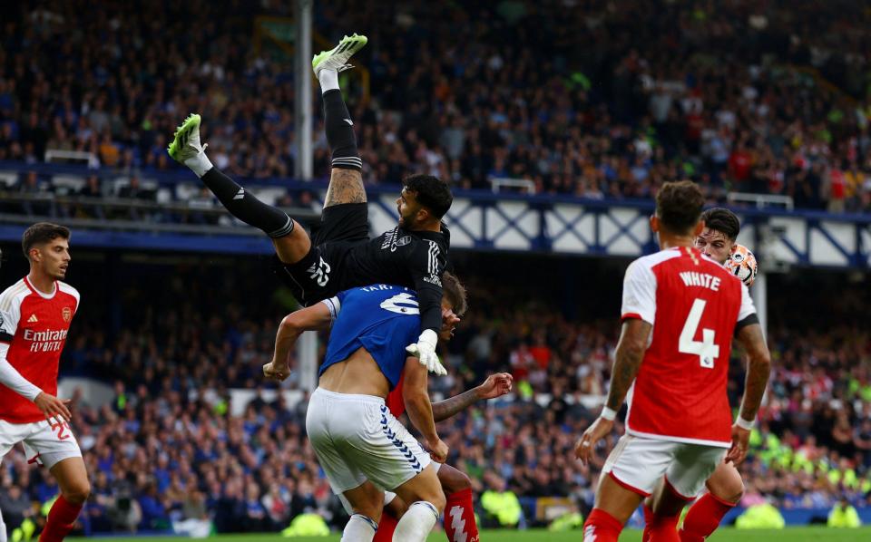 Arsenal's David Raya in action with Everton's James Tarkowski