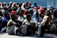Migrants rests after disembarking from Dignity ship in the Sicilian harbour of Augusta, Italy, October 19, 2016. REUTERS/Antonio Parrinello/File Photo