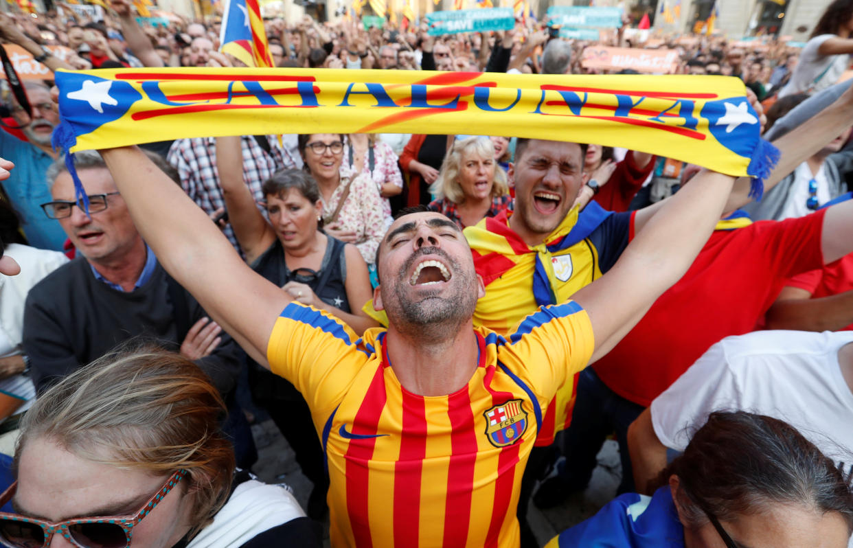 People react at Sant Jaume Square in Barcelona after the Catalan regional parliament declares independence from Spain. (Photo: Yves Herman / Reuters)