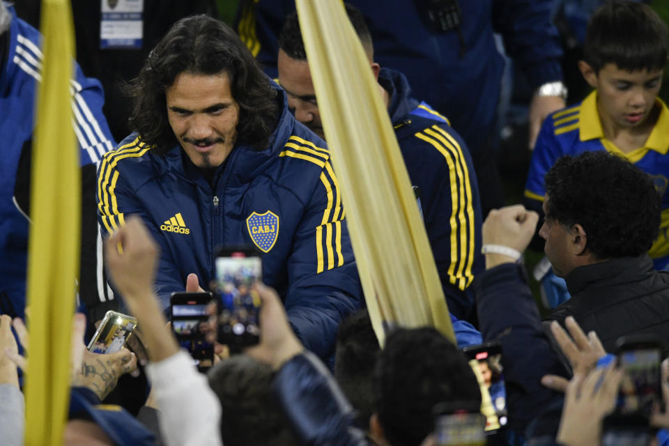 Uruguayan striker Edinson Cavani is mobbed by young fans after entering the Bombonera stadium in Buenos Aires, Argentina, Monday, July 31, 2023. Cavani has joined Boca Juniors following the termination of his contract with La Liga side Valencia. (AP Photo/Gustavo Garello)