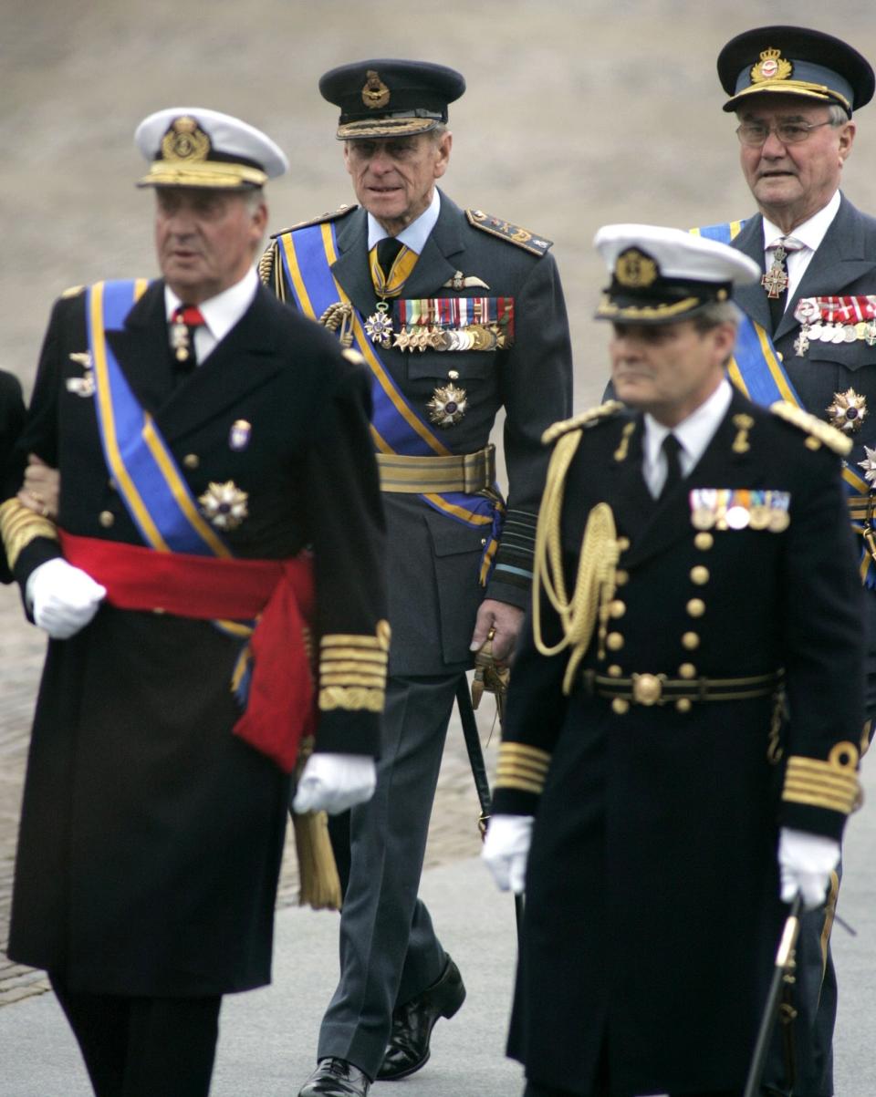 FILE - In this Saturday Dec. 11, 2004, file photo, King Juan Carlos of Spain, foreground left, Prince Philip, husband of Britain's Queen Elizabeth II, center rear, and Prince Henrik of Denmark, rear right, arrive for the funeral of Prince Bernhard of the Netherlands at Nieuwe Kerk, or New Church, in the center of Delft, The Netherlands. Prince Philip's life spanned just under an entire century of European history. His genealogy was just as broad, with Britain's longest-serving consort linked by blood and marriage to most of the continent's royal houses. (AP Photo/Fred Ernst, File)