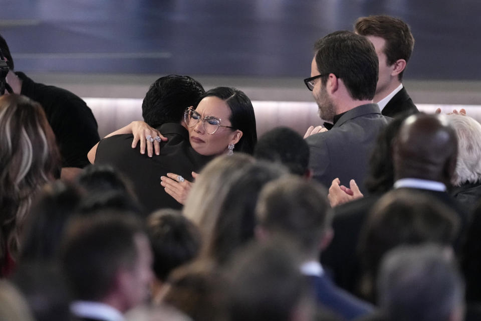 Ali Wong, left, embraces Steven Yeun after he wins the award for outstanding lead actor in a limited or anthology series or movie for "Beef" during the 75th Primetime Emmy Awards on Monday, Jan. 15, 2024, at the Peacock Theater in Los Angeles. (AP Photo/Chris Pizzello)