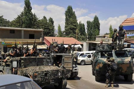 Lebanese army soldiers ride military vehicles, in Labwe in eastern Bekaa Valley August 6, 2014. REUTERS/Hassan Abdallah