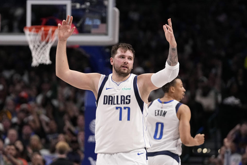 Dallas Mavericks' Luka Doncic celebrates after scoring against the Golden State Warriors during the second half of an NBA basketball game in Dallas, Wednesday, March 13, 2024. (AP Photo/Tony Gutierrez)