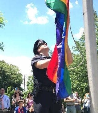 Patrolman Matthew Stanislao, who is gay, raises the rainbow flag on a pole on the first day of LGBT Pride Month at Wilde Memorial Park on Maple Avenue in Glen Rock in June 2017.