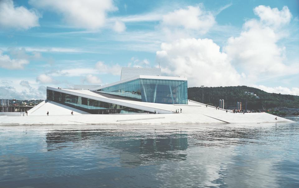 The <strong>Norwegian National Opera and Ballet</strong> was designed to be a democratic structure, where visitors—whether they hold a ticket or not—can explore the Carrara marble–clad roof plaza and lobby. Completed in 2008, the building has become the jewel of the Oslo waterfront district and spurred more development, helping to revive the area.