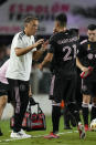 Inter Miami head coach Phil Neville talks to Inter Miami forward Julian Carranza on the sidelines during the second half of an MLS soccer match against Nashville, Wednesday, Sept. 22, 2021, in Fort Lauderdale, Fla. (AP Photo/Rebecca Blackwell)