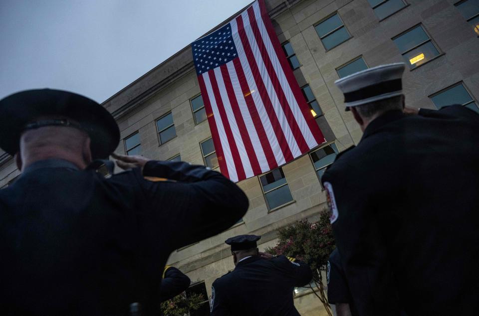 First responders stand at attention as the American flag is unfurled prior to an observance ceremony to honor the 184 people killed in the 9/11 attack at the Pentagon, at the National 9/11 Pentagon Memorial on Sept. 11, 2023. / Credit: ANDREW CABALLERO-REYNOLDS/AFP via Getty Images