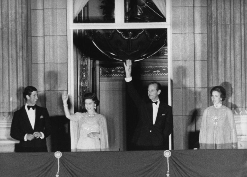 The Queen and Prince Philip, joined by Prince Charles and second-eldest child Princess Anne, wave to crowds during her Silver Jubilee.