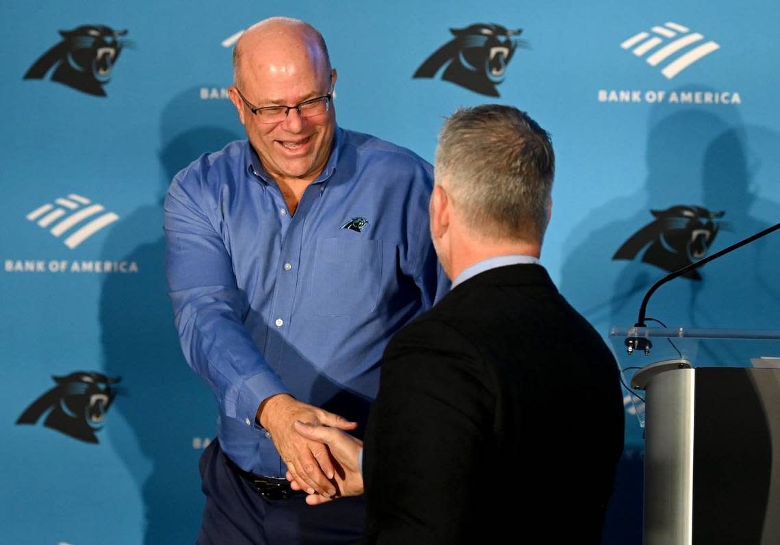 Carolina Panthers team owner David Tepper, left, greets new head coach Frank Reich, right, during Reich’s introductory press conference at Bank of America Stadium on Tuesday, January 31, 2023.