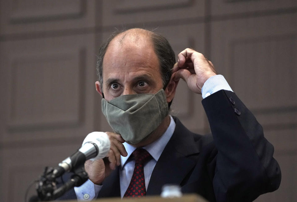 Tomas Ojea Quintana, the United Nations special rapporteur on the situation of human rights in North Korea, adjusts his face mask during a press conference at the Press Center in Seoul, South Korea, Wednesday, Feb. 23, 2022. The United Nations’ independent investigator on human rights in North Korea has called for the international community to provide 60 million doses of COVID-19 vaccines to the isolated authoritarian nation, which has recently showed signs of easing one of the world's most restrictive pandemic border closures.(AP Photo/Ahn Young-joon)