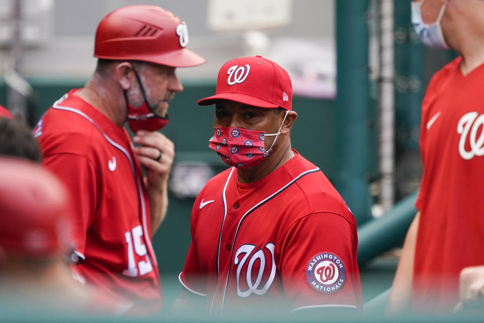 Washington Nationals manager Dave Martinez, center, walks in the dugout during the sixth inning of the second baseball game of the team's doubleheader against the Atlanta Braves at Nationals Park, Wednesday, April 7, 2021, in Washington. The Braves won 2-0. (AP Photo/Alex Brandon)