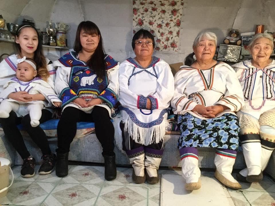 Qapik Attagutsiak (far right) sits with six generations of her family in Arctic Bay, Nunavut.