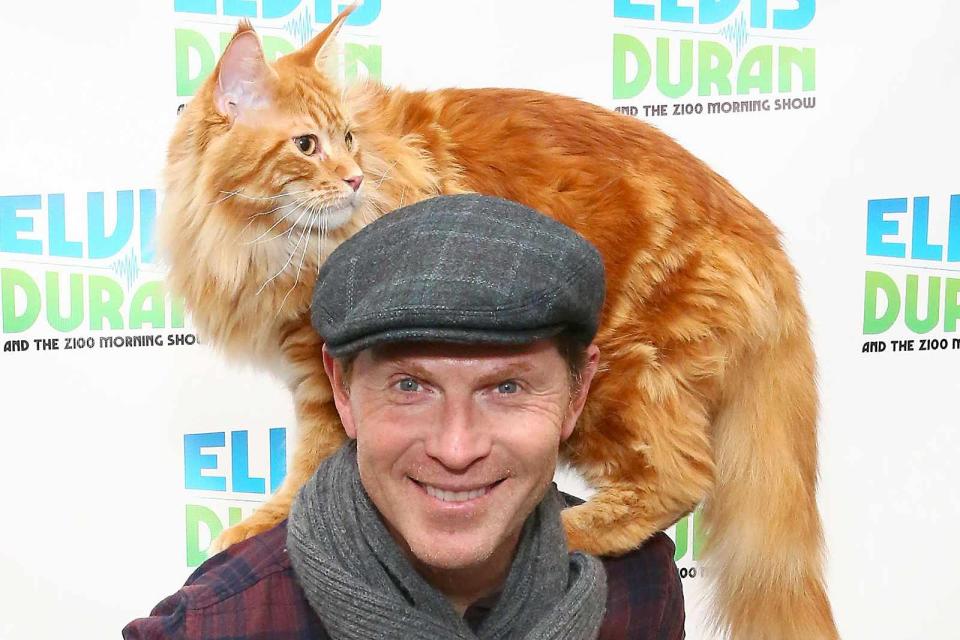 <p>Astrid Stawiarz/Getty </p> Bobby Flay and his cat, Nacho Flay