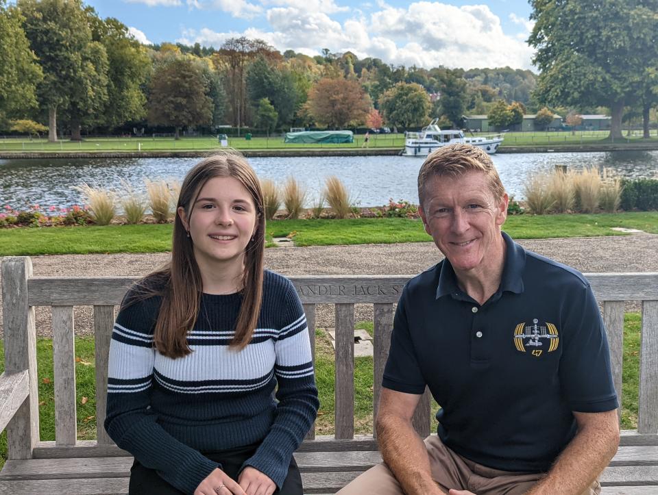 Girl sitting next to a man