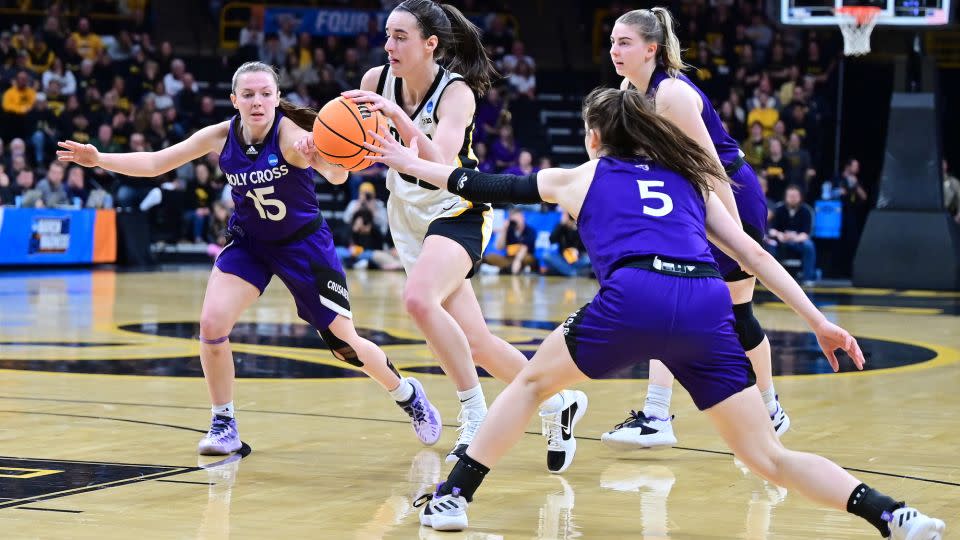 Clark drives to the basket against Holy Cross defenders. - Keith Gillett/Icon Sportswire/Getty Images