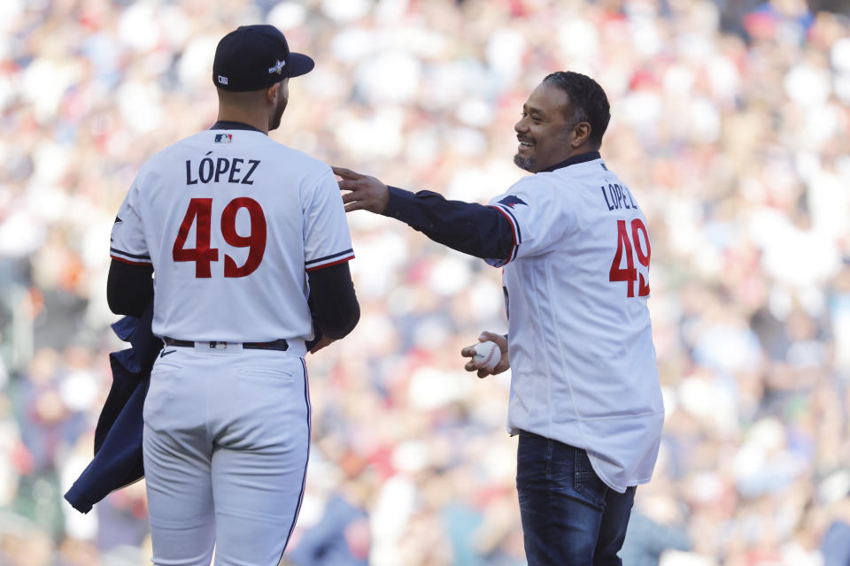 Former Minnesota Twins pitcher Johan Santana, right, wearing a Pablo Lopez jersey, talks to the current pitcher before throwing out the ceremonial first pitch before Game 3 of an American League Division Series baseball game against the Houston Astros, Tuesday, Oct. 10, 2023, in Minneapolis. (AP Photo/Bruce Kluckhorn)