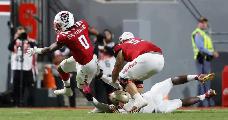 N.C. State running back Demie Sumo-Karngbaye (0) tries to escape Florida State defensive end Leonard Warner III (35) during the first half of N.C. State’s game against Florida State at Carter-Finley Stadium in Raleigh, N.C., Saturday, Oct. 8, 2022.