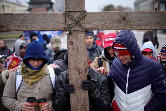 Supporters of then-President Donald Trump pray outside the U.S. Capitol on Jan. 6, 2021, in Washington, DC.