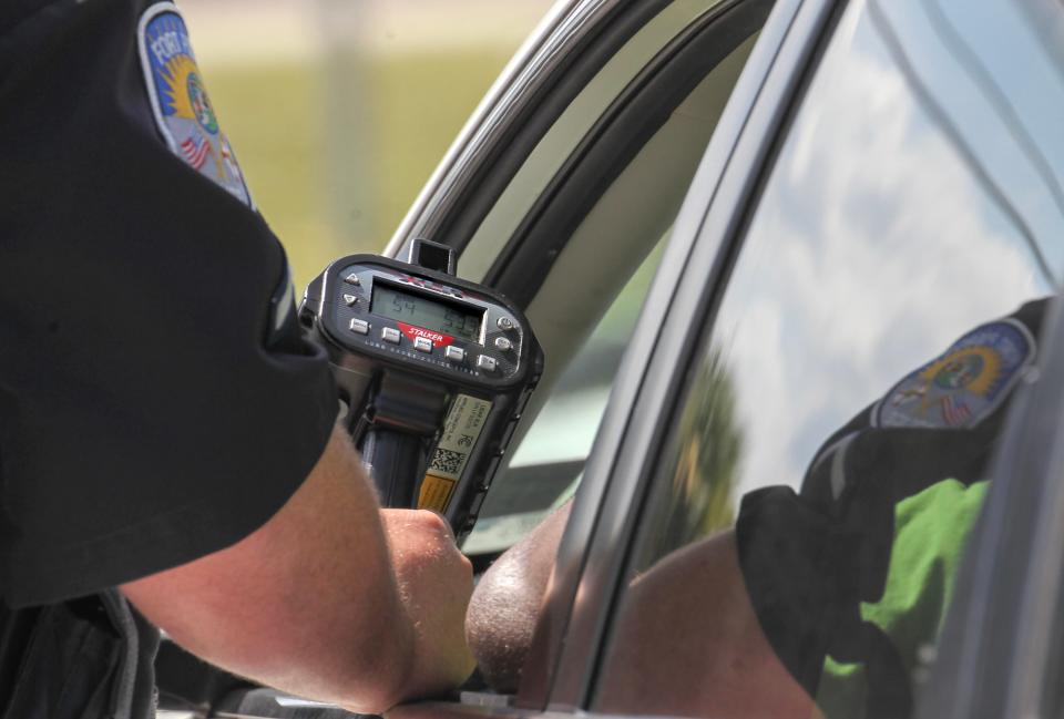 A Fort Pierce police officer shows a driver his speed on a radar device while conducting speed enforcement along Okeechobee Road Road on Wednesday Sept. 6, 2023, in Fort Pierce. Police have been stepping up traffic enforcement along Okeechobee Road near I-95 where traffic is increasing because of a growing population and business growth.