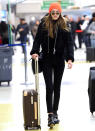 <p>The top model made her way through JFK in a sleek black hoodie, matching cropped Mother jeans ($196; <a rel="nofollow noopener" href="http://www.motherdenim.com/the-high-waisted-looker-notguilty" target="_blank" data-ylk="slk:mother.com;elm:context_link;itc:0;sec:content-canvas" class="link ">mother.com</a>), and cool studded boots. She topped off her effortless ensemble with an orange beanie, sunglasses, a black leather Mansur Gavriel bag ($895; <a rel="nofollow noopener" href="https://www.mansurgavriel.com/products/lady-bag-black/flamma" target="_blank" data-ylk="slk:mansurgavriel.com;elm:context_link;itc:0;sec:content-canvas" class="link ">mansurgavriel.com</a>), and a Louis Vuitton roller suitcase.</p>