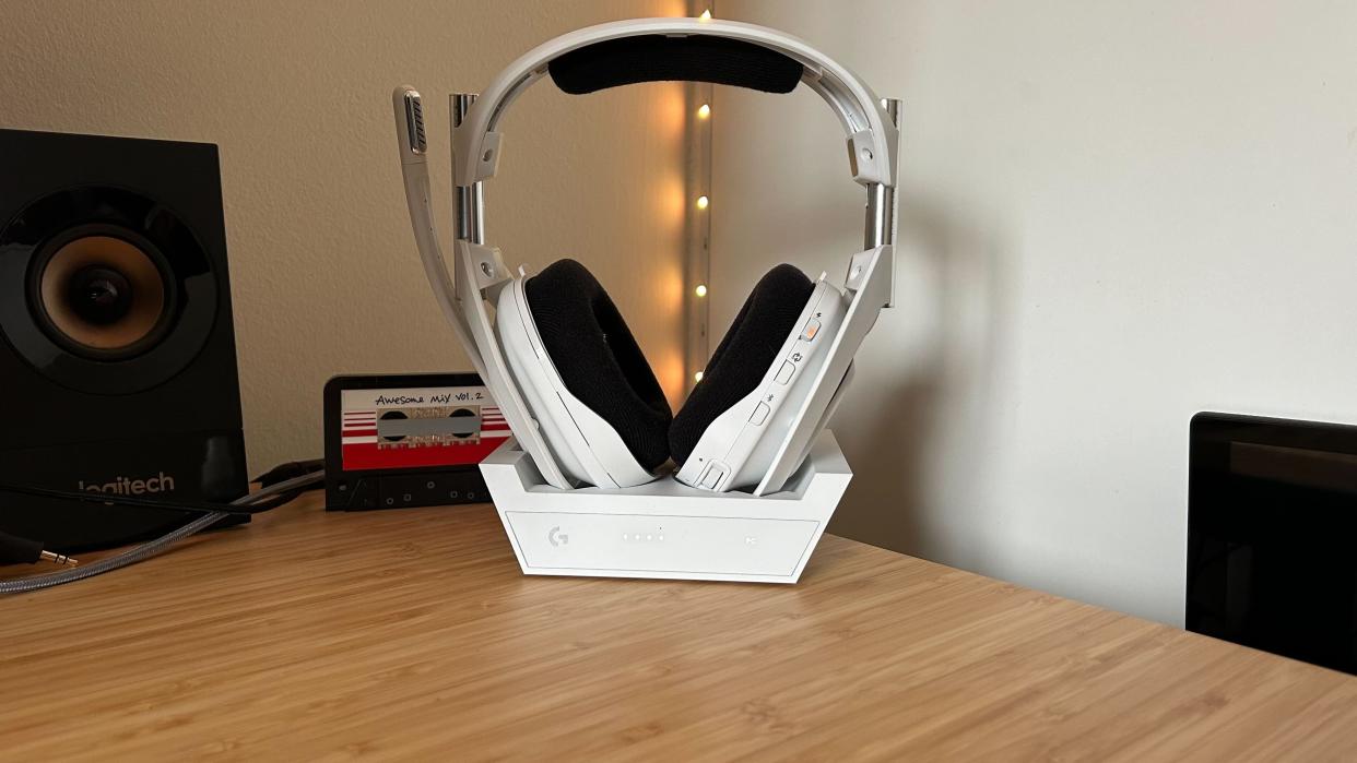  Astro A50 X in charging cradle on a wooden desk. 
