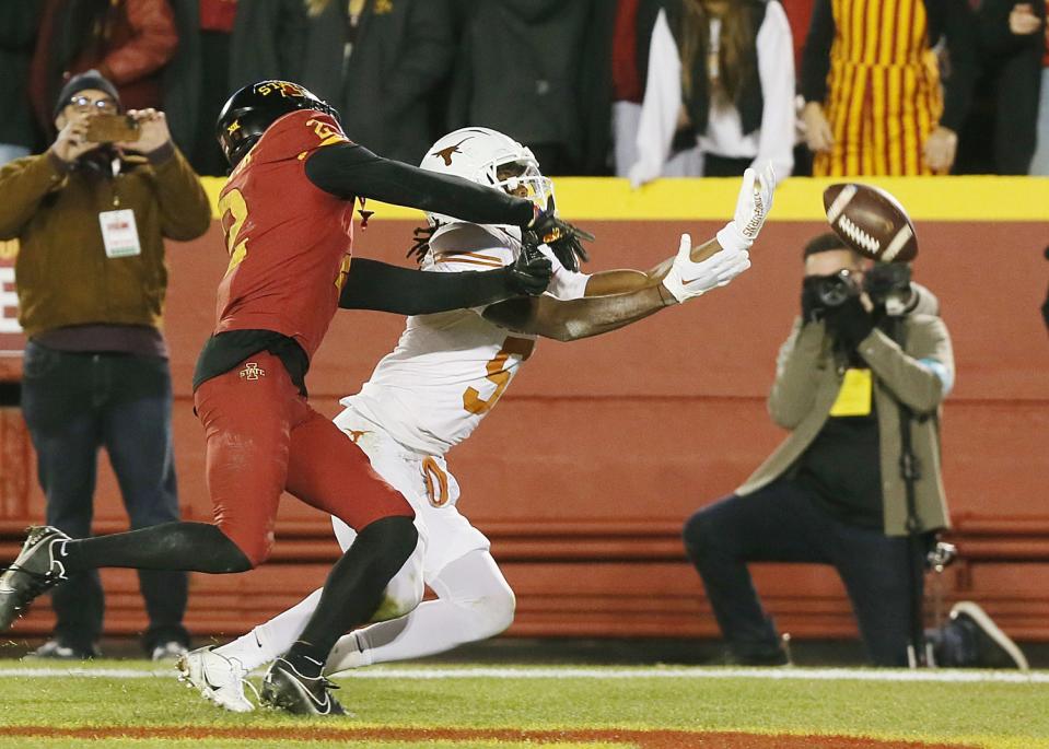 Iowa State Cyclones’ defensive back T.J. Tampa (2) knocks out a pass intended to Texas Longhorns wide receiver Adonai Mitchell (5) during the second quarter in the Big-12 football showdown at Jack Trice Stadium on Saturday, Nov. 18, 2023, in Ames, Iowa