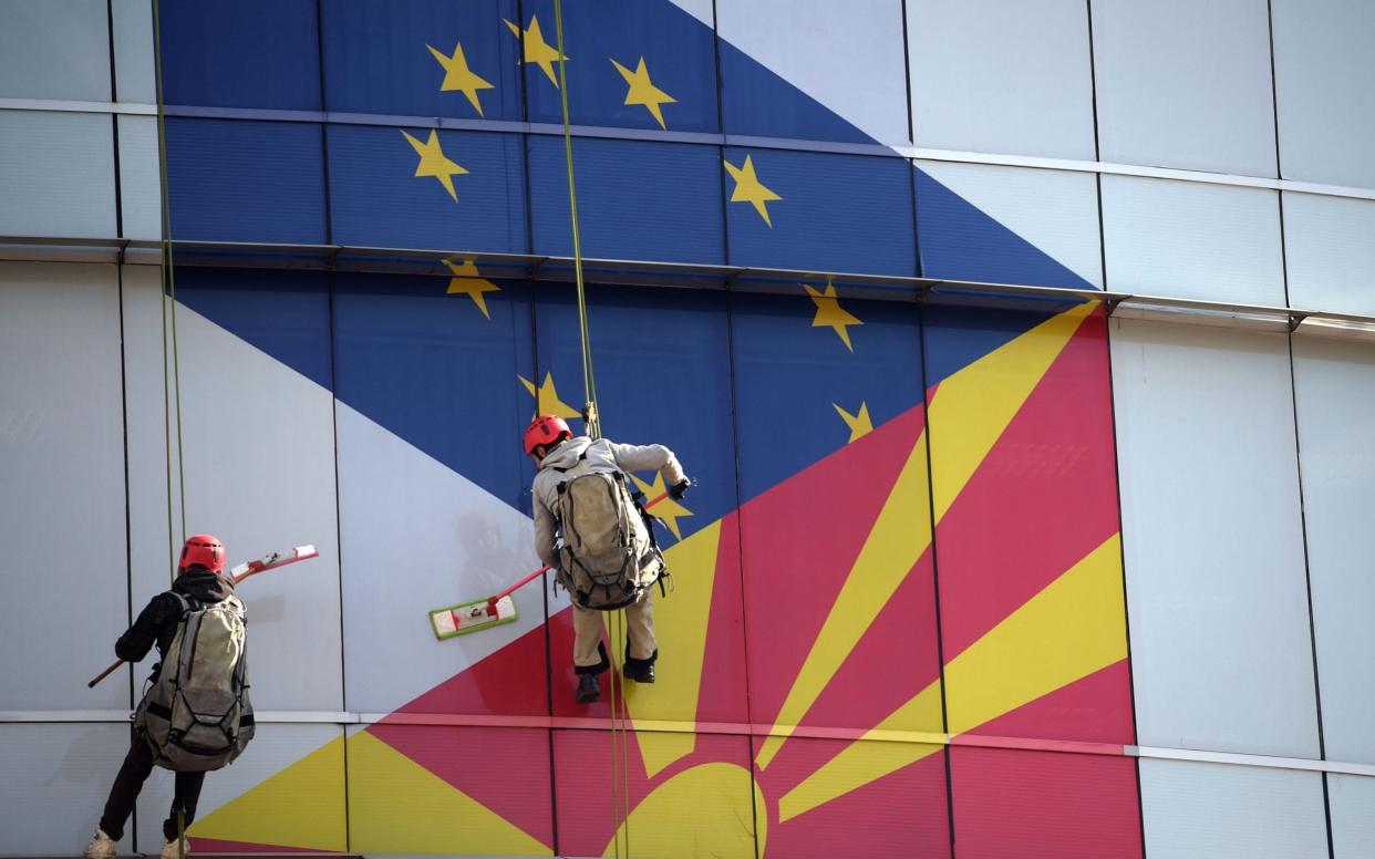 The European Union and Macedonian flags decorate the windows of the EU office in Skopje, North Macedonia - REX